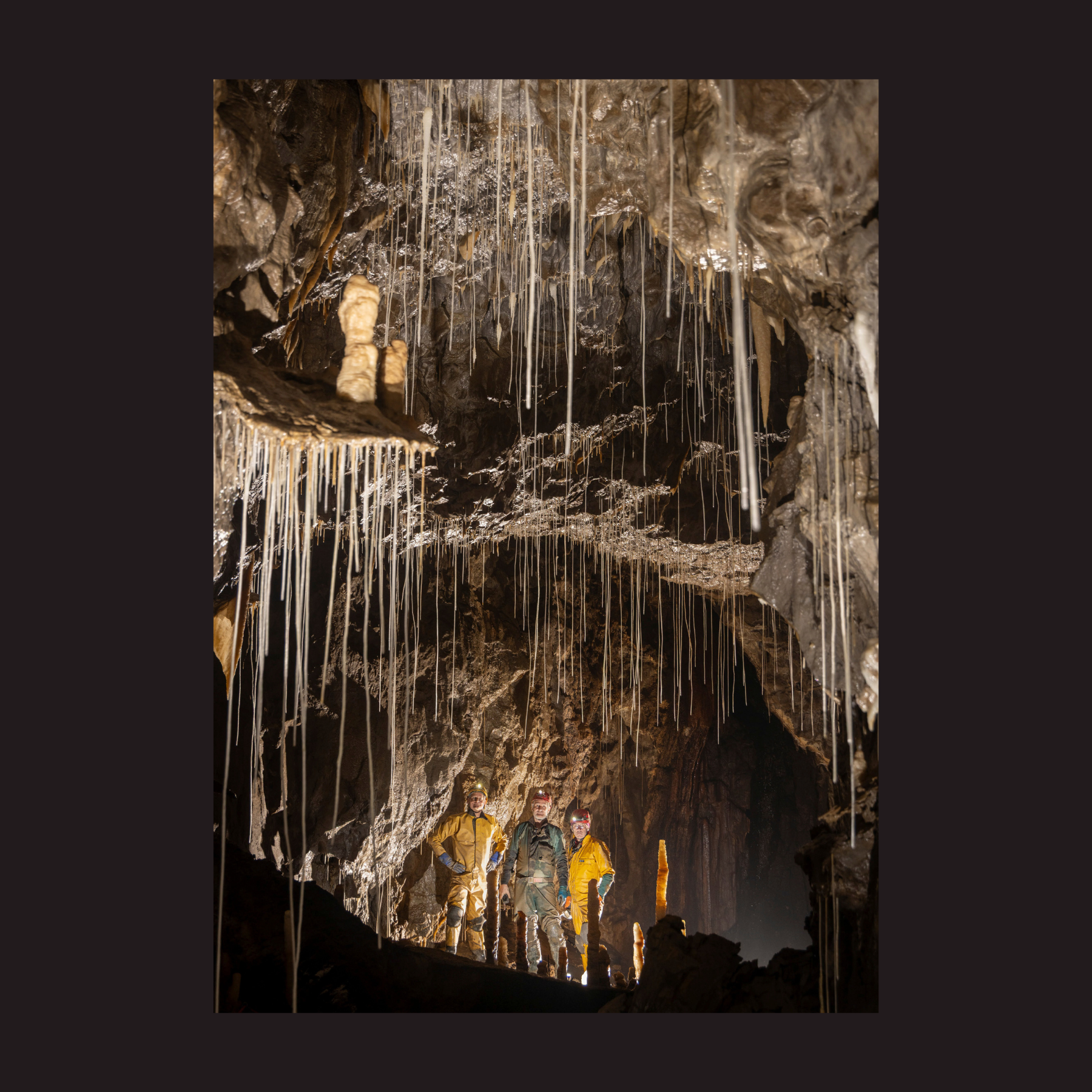 Descent 310 back cover - Tim Allen, Nick Bairstow and Dave Gledhill in the Echo Chamber, Gavel Pot, Yorkshire Dales Photo: Bartek Biela